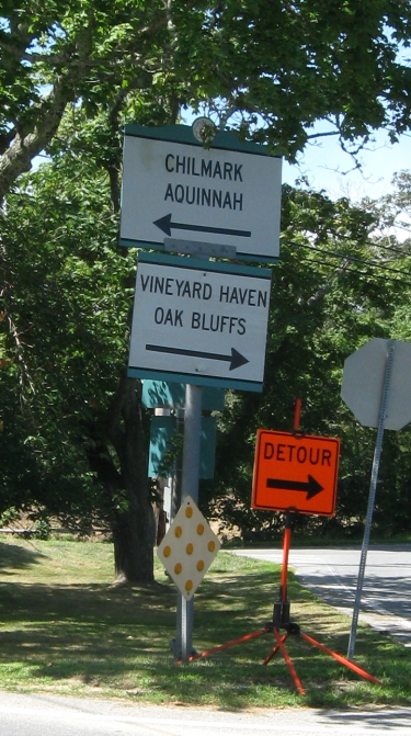 Detour sign at West Tisbury triangle, pointing right toward North Rd. even though the better route from this point is left toward Music St. to Middle Rd.