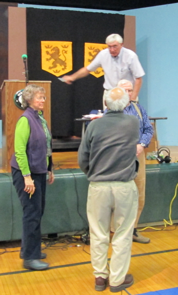 Moderator Pat gives instructions to the volunteers who are about to count our raised hands.