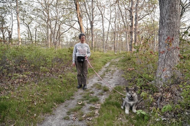 Susanna and puppy Tam in the woods